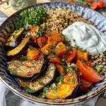 Close-up view of a delicious Auberginen bowl with quinoa and toppings.