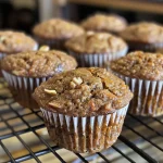 Close-up of moist Morning Glory Muffins with visible nuts and shredded apple.