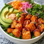 A close-up view of a Hot Honey Chicken Bowl featuring colorful ingredients.