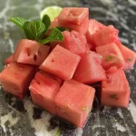Close-up of a refreshing watermelon drink with mint leaves.