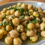 Close-up image of roasted curry chickpeas arranged in a bowl.