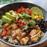 A close-up view of a colorful chicken burrito bowl filled with fresh ingredients.