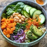 Close-up view of a colorful protein-packed veggie bowl featuring quinoa, beans, and fresh vegetables.